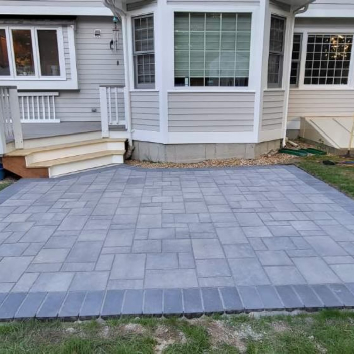 construction of a new paver patio and stairs attached to the deck