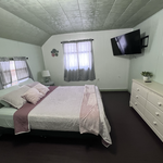 Bedroom number one after stripping sheets & blankets, washing, remaking the bed, dusting, sanitizing, and mopping