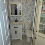 New toilet, vanity and a new tile floor. Customer wallpapered and painted .