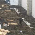 Back filling the fox block footing system after insulation placed at lower footer.