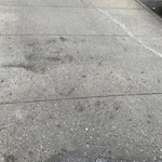 Sidewalk oil stain . Before cleaning