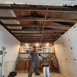My assistant William preparing the floor with cardboard and canvas to prevent any damage from demolition.