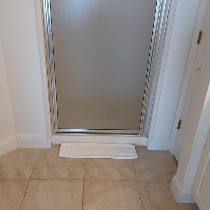 Images from our condo cleaning of a glass shower 07/30/2023