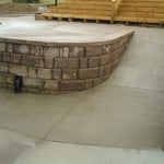 Inground swimming pool, retaining wall , colored concrete, wood staircase