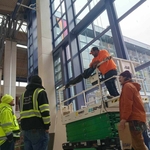 Passing the glass through to the outside with a scissor lift.