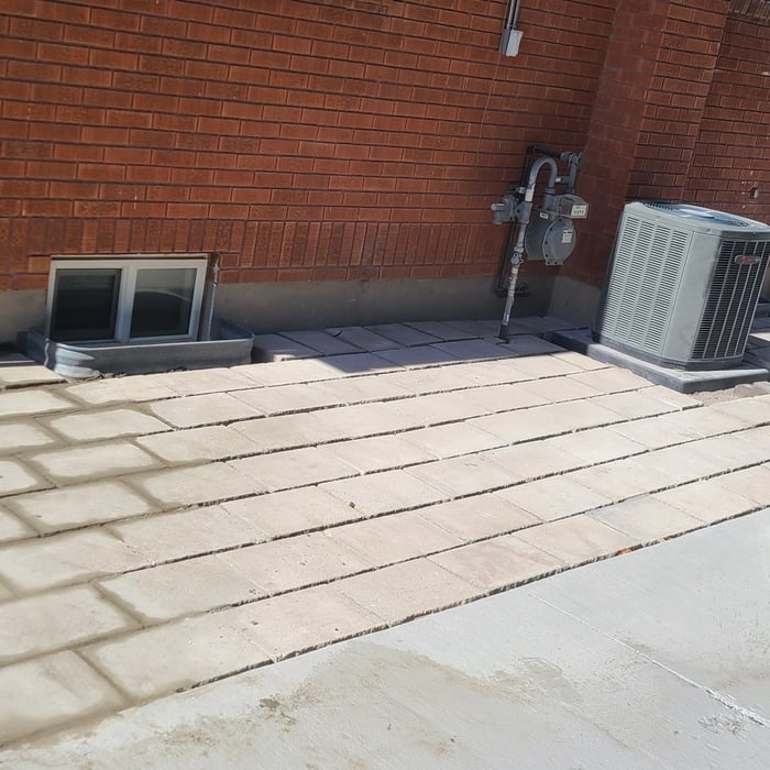 Tear out on grass area , replaced with pavers and grout