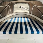 Made to measure, folding bow pad in striped outdoor Sunbrella fabric.
