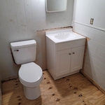 Tore out floor and leveled joists underneath half bath and installed new sub flooring. Reinstalled toilet, vanity and lighting.