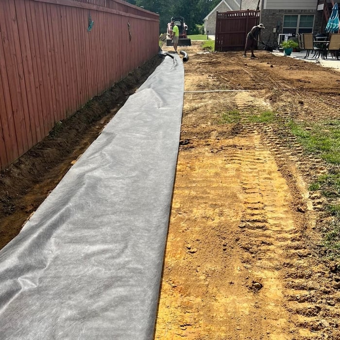 After we excavated the ditch we laid down erosion fabric to prevent further future erosion.