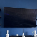65" Television mounted with wires hidden with wire cover bracket.