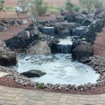 Large natural water feature with pond and lights