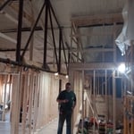 Standing in the meeting room. Offices to the left and common area to the right