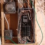 Outdated 100-amp service panel with no room for expansion. Needed additional circuits for master bath and bed addition.