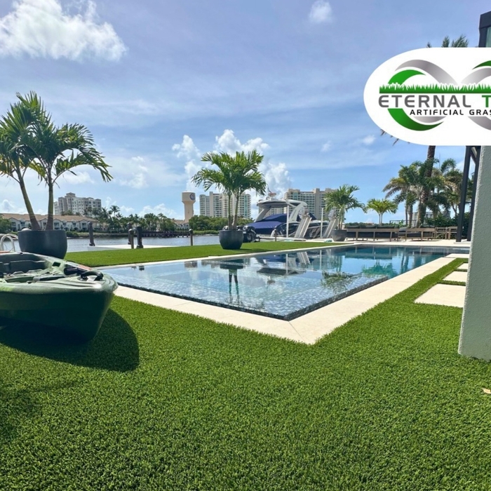 Client with oceanfront views and a gorgeous swimming pool features lush artificial lawn grass to complete their backyard paradise.