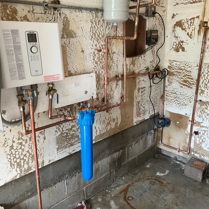 Electric tankless water heater hooked to solar. With recirculating pump time for busy uses.