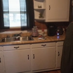 Interior painting cabinets I'm painting them white they was Brown sanding and caulk .