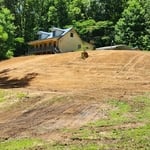This image shows the final dirt work and the new, more gentle slope of the yard.