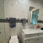 Motion toilet, fog less medicine cabinet, tile floor to cieling.