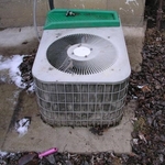 A/C condenser cemented to the ground