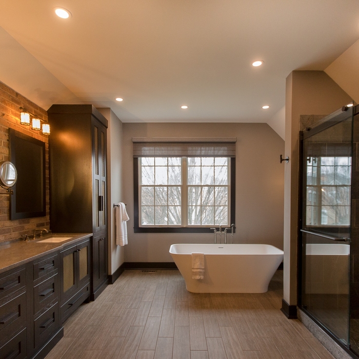 This industrial style master bath in Blue Bell, PA is truly one-of-a-kind. Pictures just don’t do this beautifully unique space justice. From the brick accent walls to the soapstone shower, this homeowner opted for the alternative look at every turn. Factory-style cage light fixtures and pipe-style accessories (robe hook and toilet tissue dispenser, to name a few) are the pièce de résistance in this space, creating the ultimate “industrial” environment. A large soaking tub and vaulted c