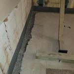 New basement drainage channels installed along the basement foundation walls