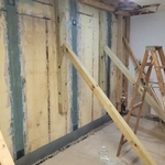 Installation of carbon fiber straps and epoxy to lock the foundation wall back into the proper position.