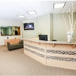 Custom built reception desk for office complex, with granite top and tile inlay.
