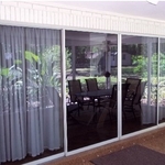 Old sliding glass doors before ATi with River Rock patio.