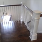 Custom staircase installed with new wood spindles painted.