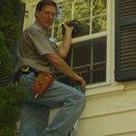 Owner Kevin installing a storm window