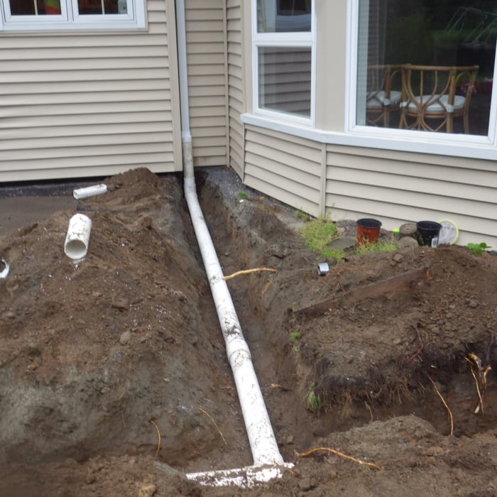 Installing 4" PVC pipe to divert water away from foundation
