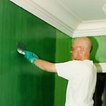 The striated surface is shown as it is being textured with a special brush. This final application proceeds only after client approval of the test swatches in the actual space and lighting conditions.
