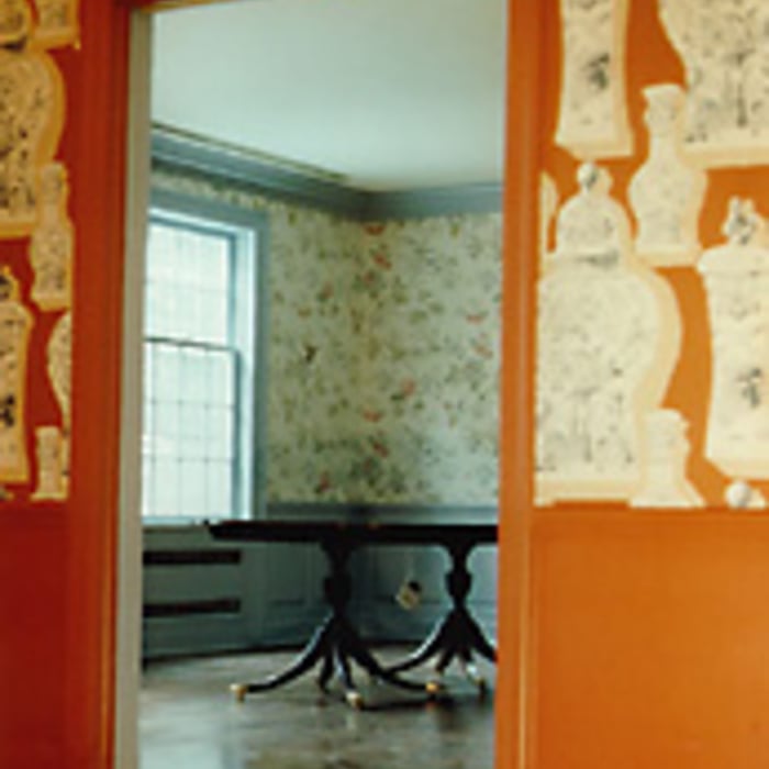 The same style is continued in the dining room with a different paper pattern and color scheme.