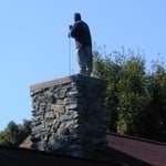 Sweeping a chimney flue from the top. Only a small portion of chimneys require the old method of sweeping a flue from the top.