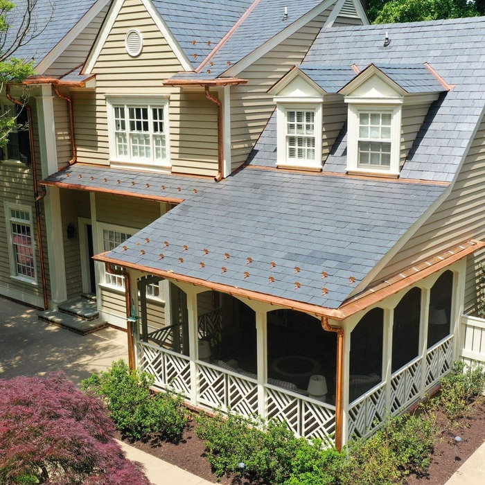 Back of the home features intricate copper gutter system work.