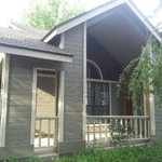 This home features a more modest grey with white trim. This type of color scheme allows the windows and porch area to be highlighted, drawing the eye even from the road.