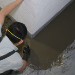 SuperCrete Basement Floor after the installation of a full-perimeter waterproofing system.