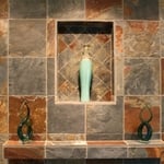 This is a close up detail of the slate fireplace, highlighting the shelf insert that was created by pushing out the new hearth a few inches to allow for a recessed display shelf & focal point. The mantle, reduced dramatically in size from its predecessor, is covered with the same slate, producing a subtle effect that would compliment rather than overwhelm or compete with the hearth wall.