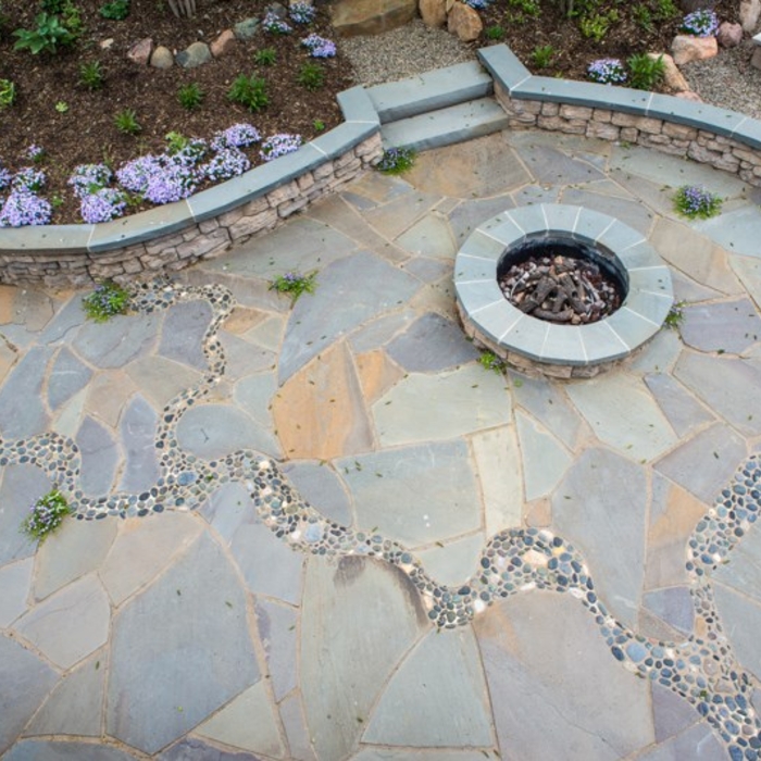 This patio has a natural feel due to the irregular cut stone with a "river" of stone running through it.
