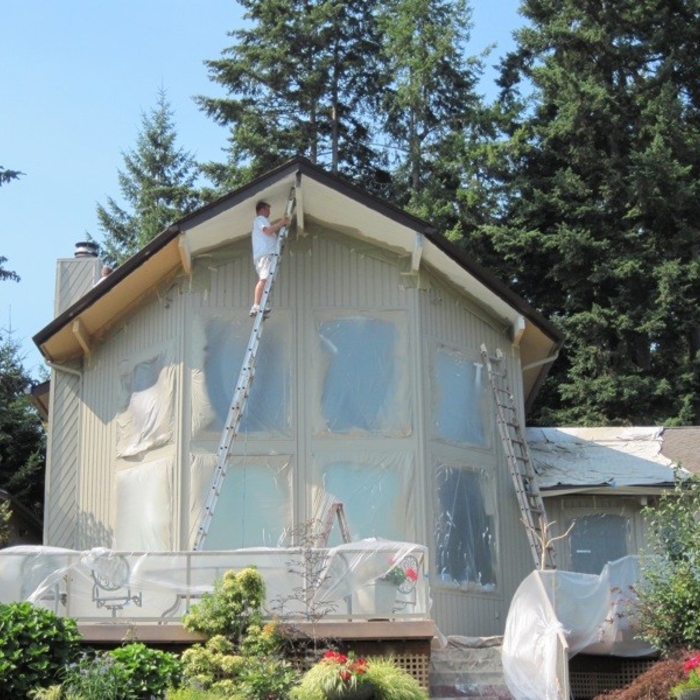Jim is painting the soffits after priming. Since the interior ceilings are the same clear wood as the exterior, the customer chose a color that compliments the interior.