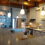 Empire Painting transformed cherry cabinets in this impressive Third Ward condo into a timeless, transitional gray.
Mid-sized minimalist l-shaped light wood floor, beige floor and wood ceiling eat-in kitchen photo in Milwaukee with a single-bowl sink, recessed-panel cabinets, gray cabinets, marble countertops, white backsplash, ceramic backsplash, stainless steel appliances, an island and white countertops