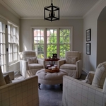 Empire Painting transformed this bright sunroom in Wauwatosa featuring tile flooring, cozy white furniture, light gray wall and ceiling paint, and contrasting light fixtures.
Mid-sized transitional ceramic tile and gray floor sunroom photo in Milwaukee with no fireplace and a standard ceiling