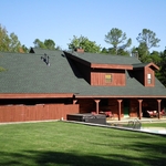 back of house after restaining and new roof