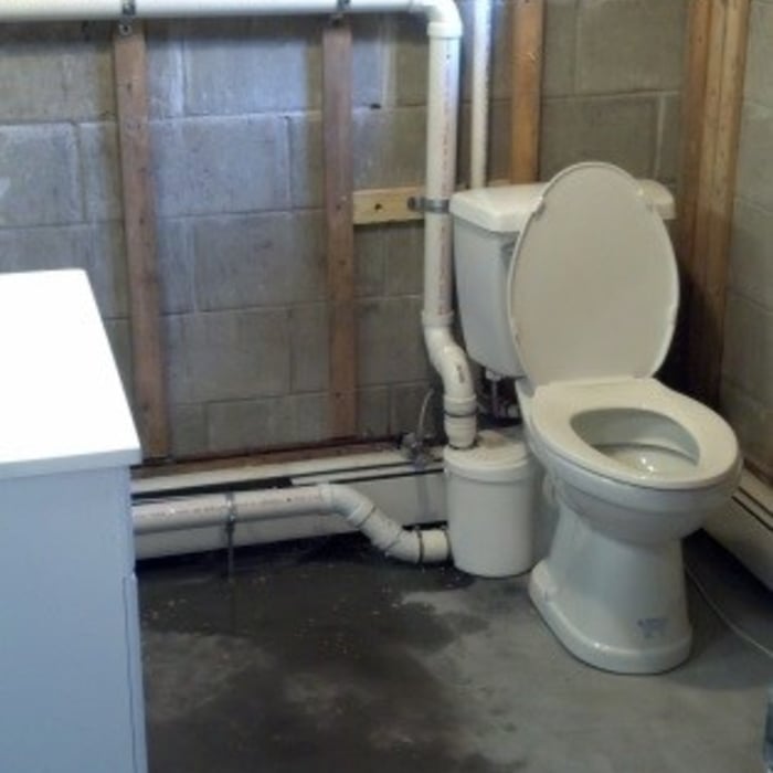 Saniflo System installed to resolve issues with elevation of main sewage drain pipe.