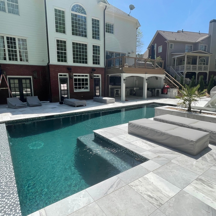 We ran conduit around the swimming pool and installed three pairs of Sonnance outdoor speakers and an underground subwoofer.