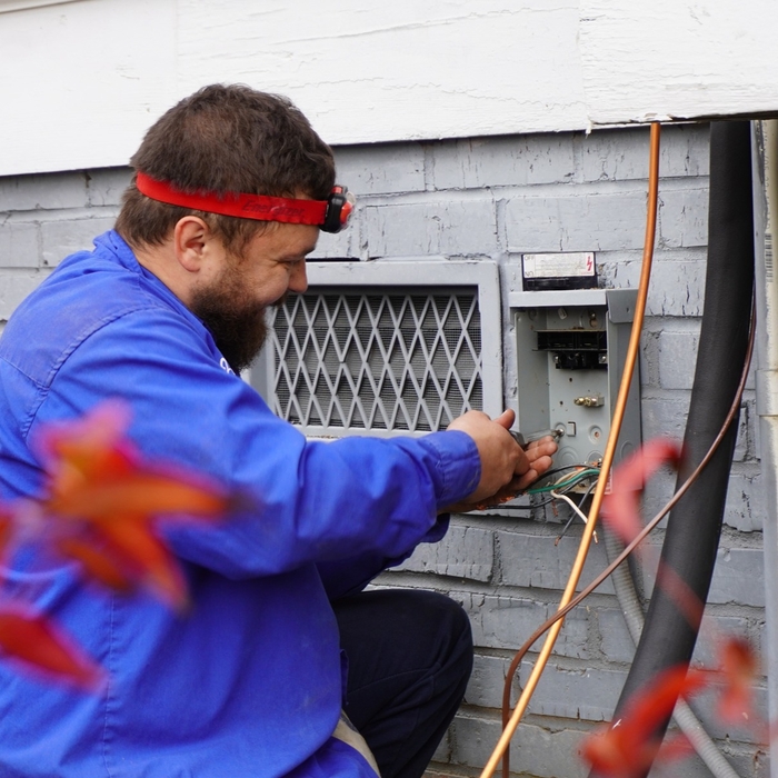 Installing the outdoor disconnect for the outdoor unit.