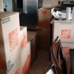 Close and tape boxes to secure items for easy loading and transport