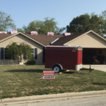 Before - Beige siding with brown roof. New roof and siding are ready to be installed.