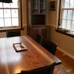 Curly walnut dining table and china cabinet