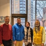 Prestissimo CEO carl scott with Hannan Center Staff taking a photo in recognition of in-kind donation of free window cleaning services